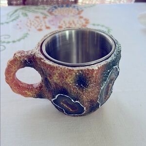 Artistic Ceramic and Metal Mug with Earthy Tones